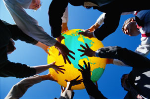 Group holding up a globe